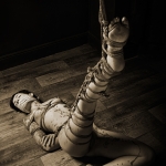 Floor bondage partial suspension leg bondage.